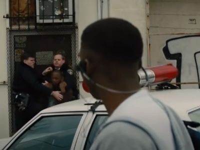 A man is being arrested by the cops as the guy is looking.